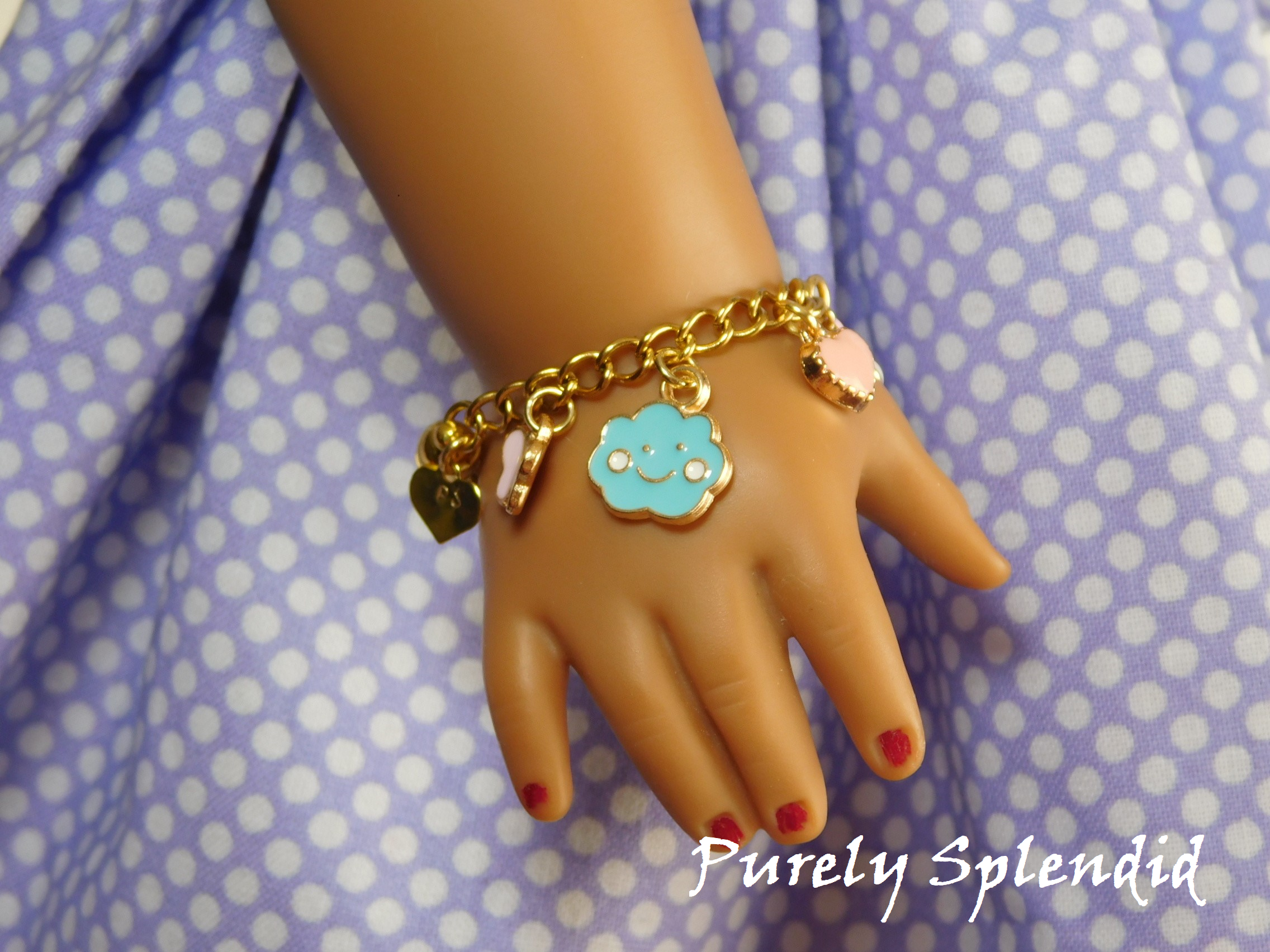 18 inch doll shown wearing a Happy Charm Bracelet with a blue happy cloud, pink butterfly and pink heart charm