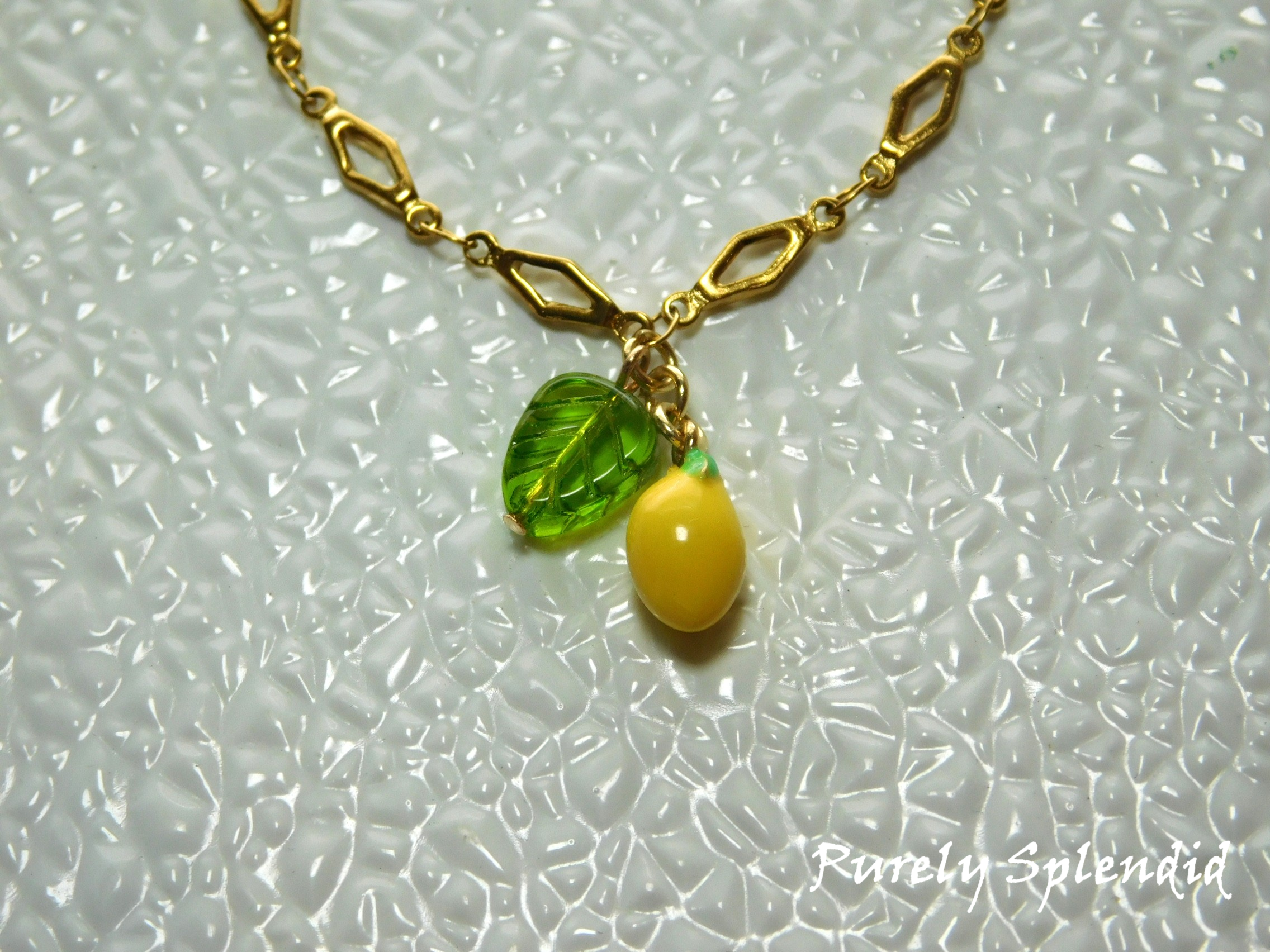 Lemon and leaf hanging from decorative chain