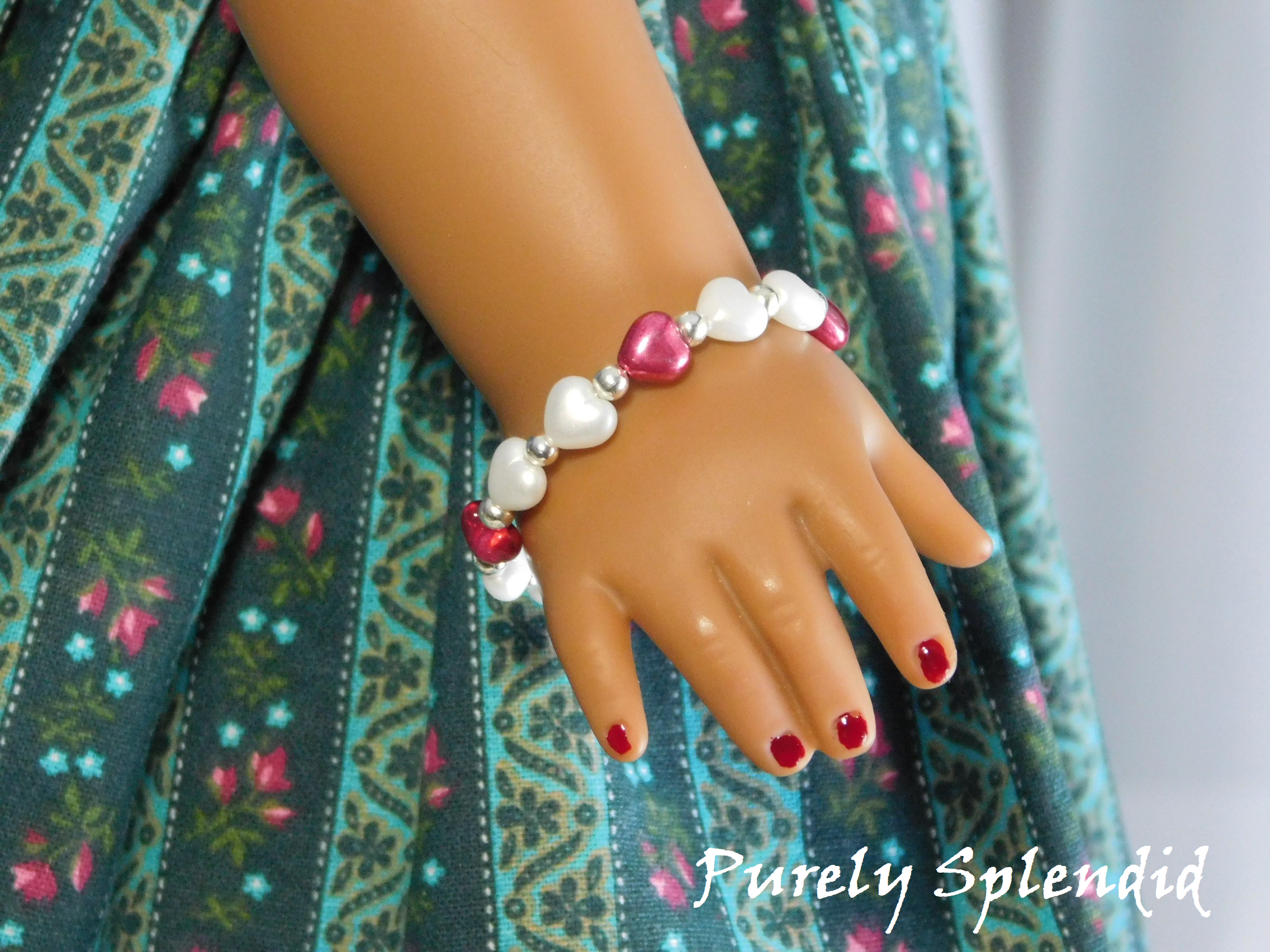 Glass Pink and White Heart beads with a small silver bead in between worn by an 18 inch doll