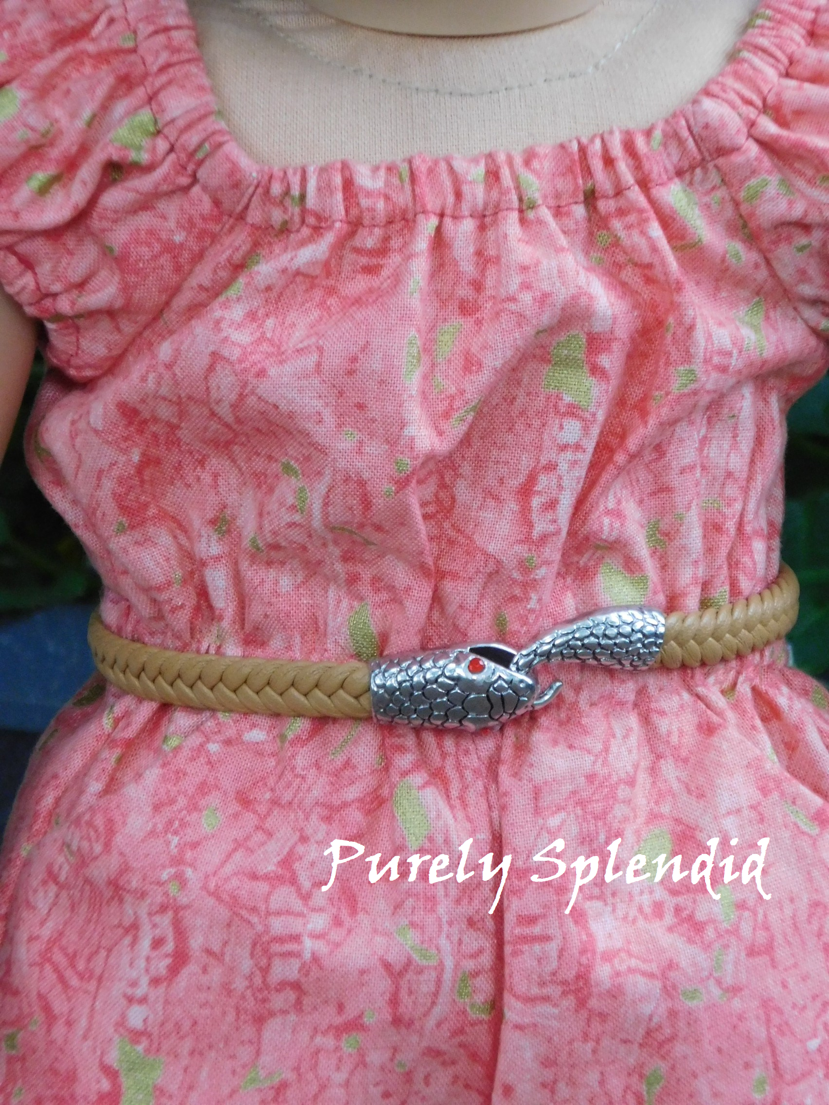 18 inch doll shown wearing a tan braided belt with snake head holding its tail