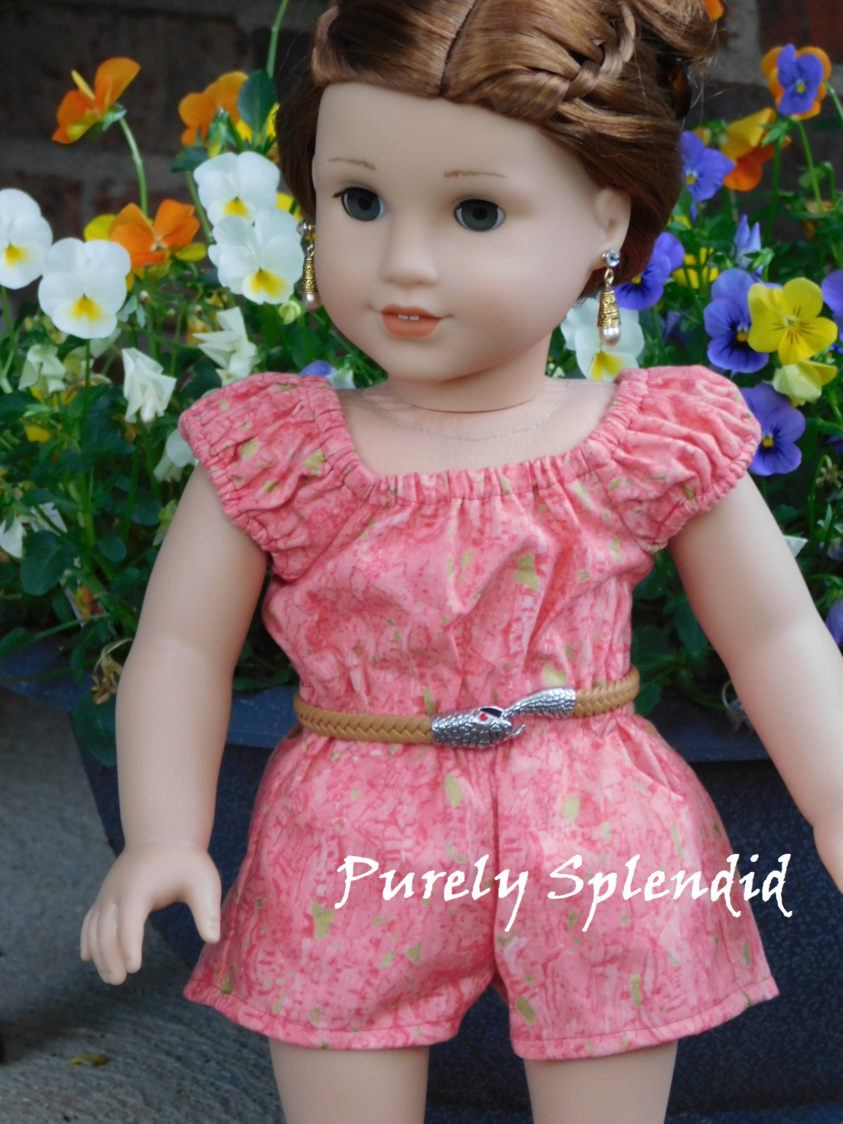 18 inch doll shown wearing a tan belt with snake head holding its tail