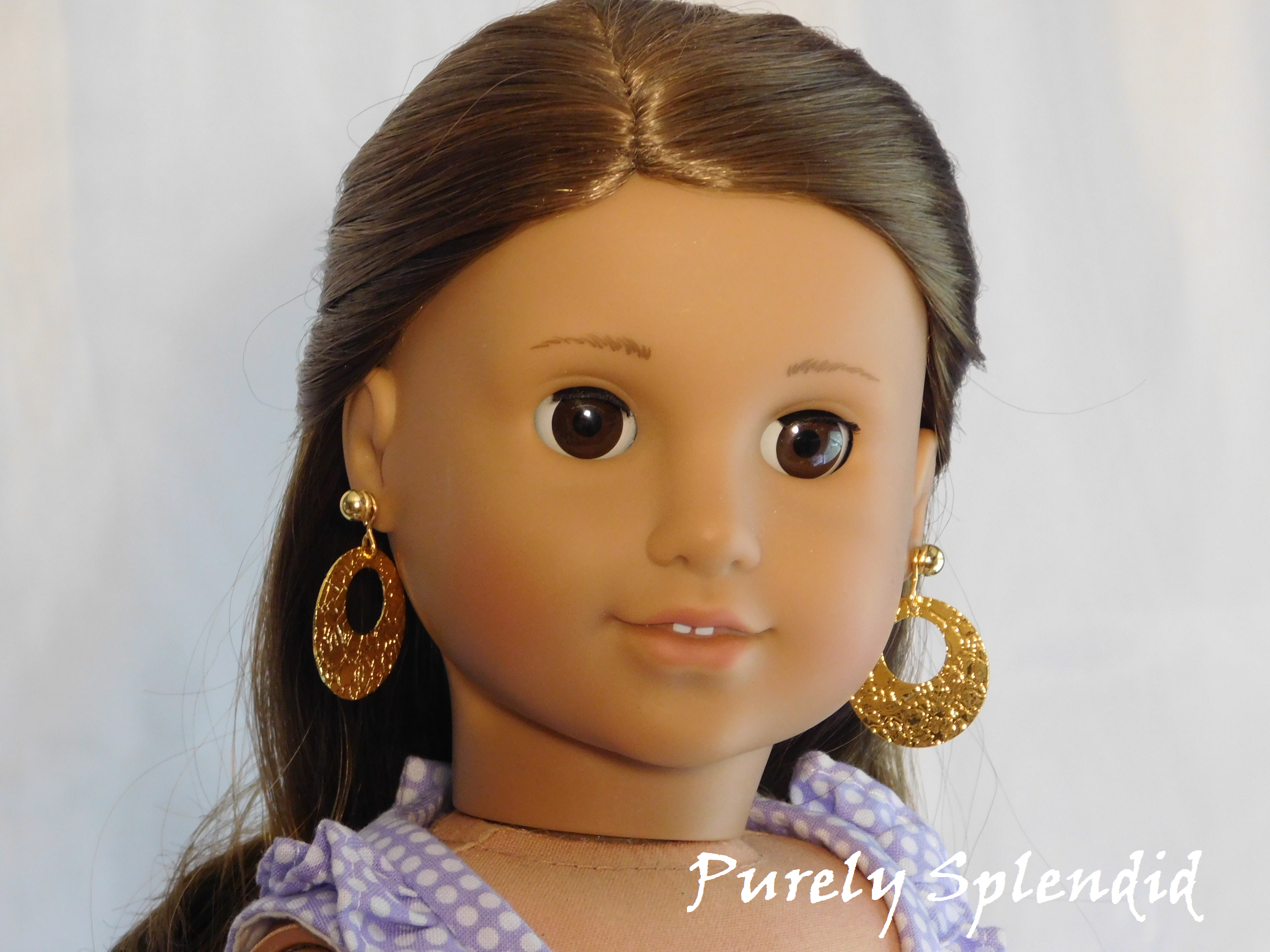 18 inch doll shown wearing a pair of Gold Textured Flat Hoop Earrings along with a pair of Small Gold Classic Studs
