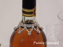 Load image into Gallery viewer, close up of the Sparkling Aurora Borealis Wine Bottle Bline Necklace shown on a standard size white wine bottle
