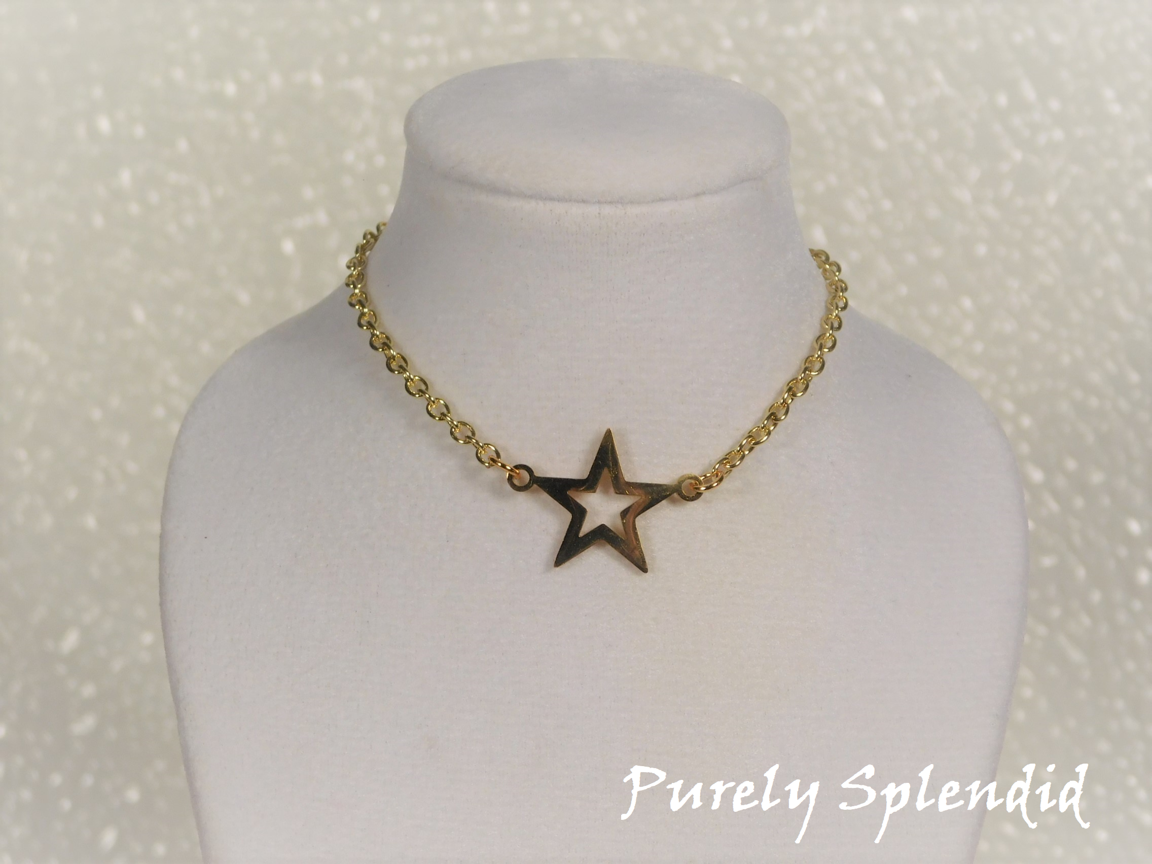 open gold colored star on a gold colored chain