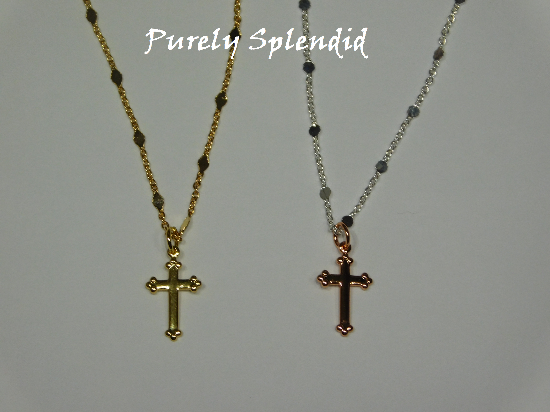 two decorative crosses, one rose gold and the other gold on decorative chains
