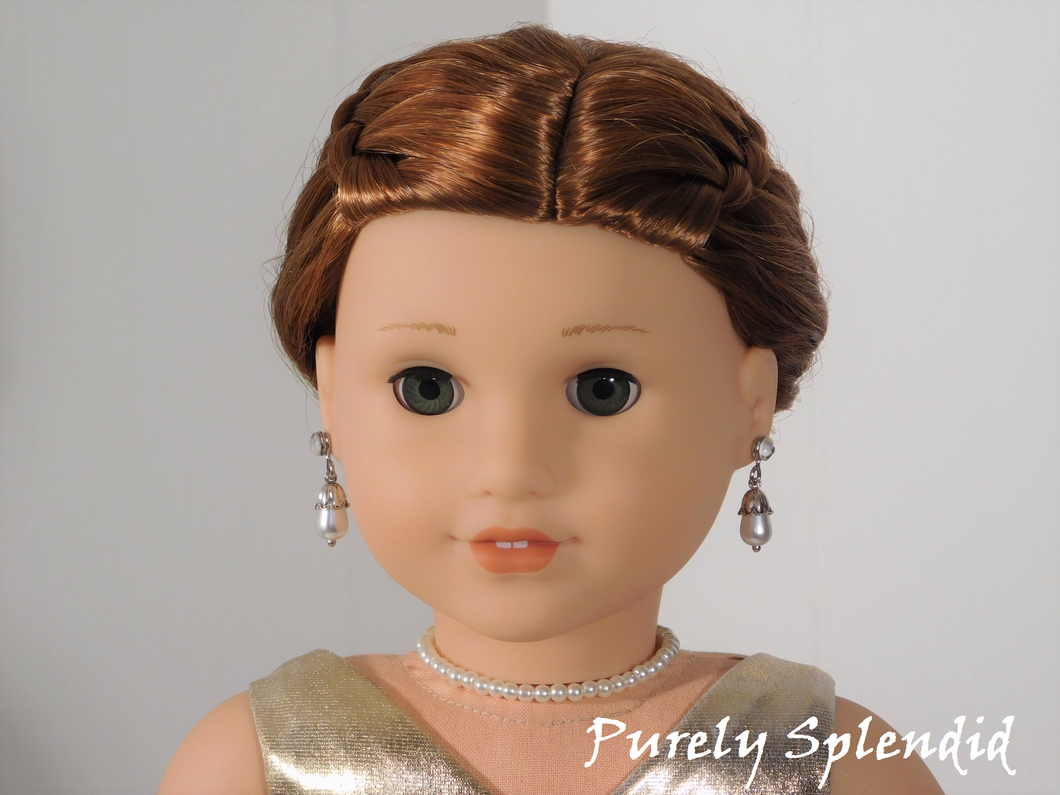 18 inch doll shown all dressed up wearing a string of white pearls 