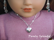 Load image into Gallery viewer, 18 inch doll shown wearing a Silver Heart Locket with pink center stone
