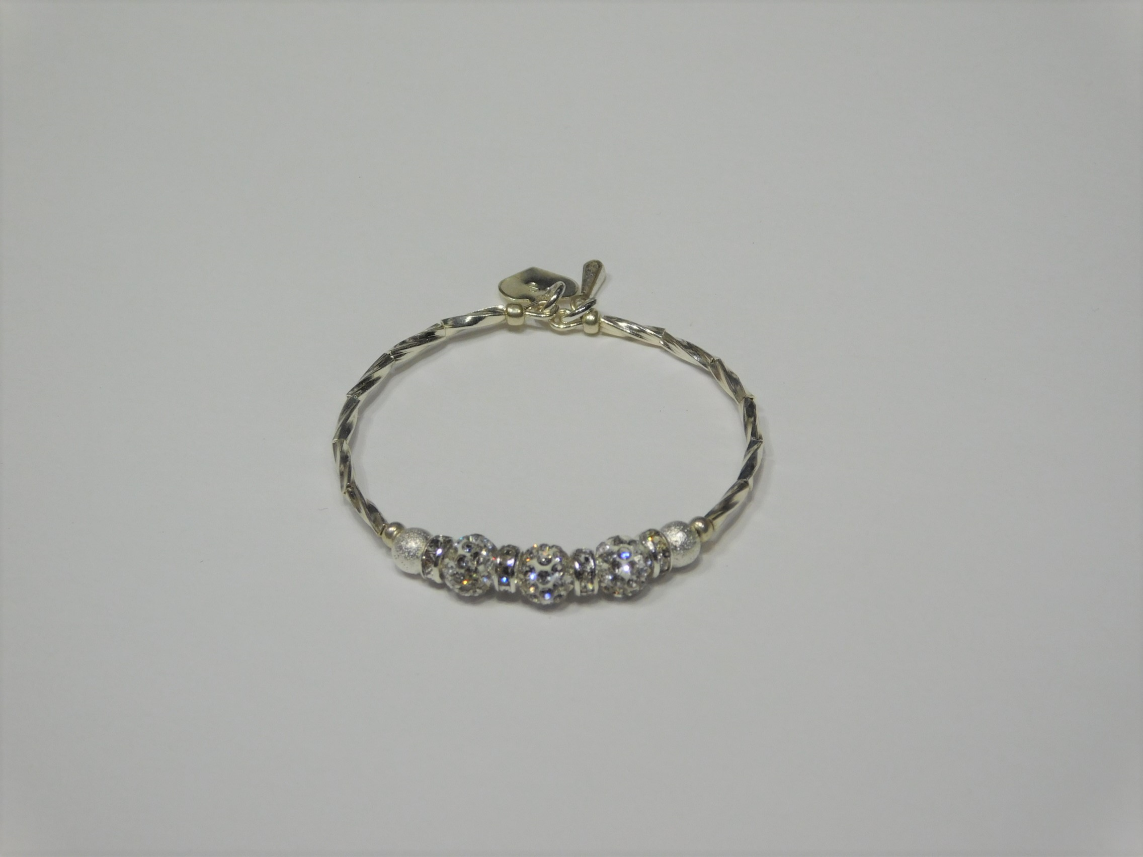 Silver bracelet with three round sparkling silver beads each surrounded with a ring of sparkle