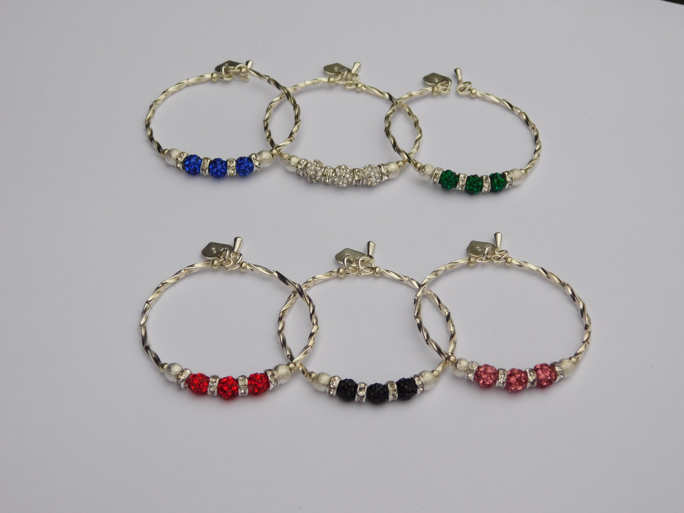 Silver base Sparkling Evening Stacking Bracelets shown in six color options