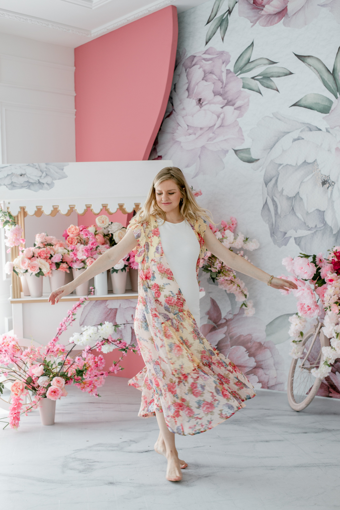lady twirling in a floral jacket