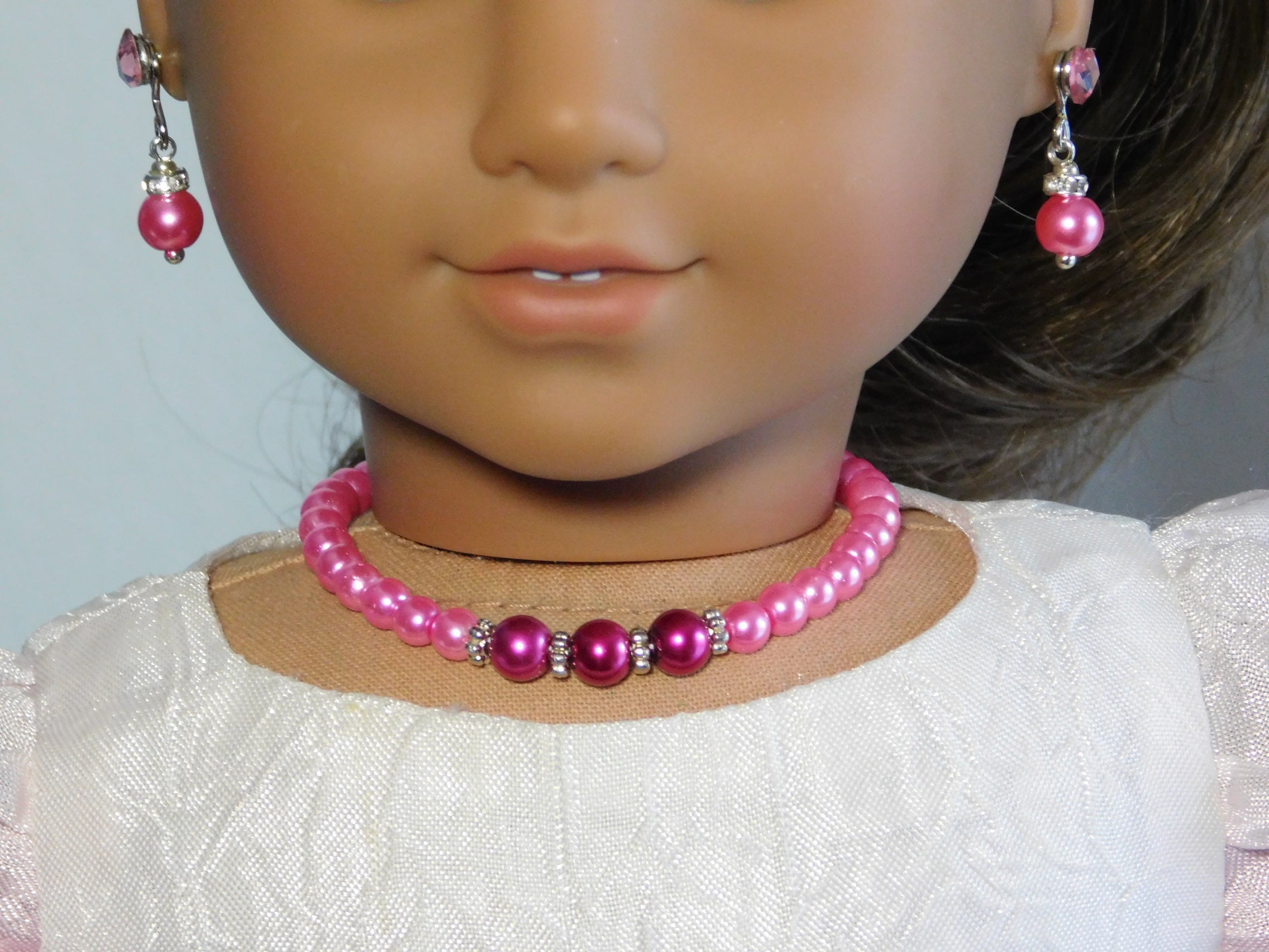 18 inch doll wearing a Bold Pink Pearl Necklace and Sparkling Pearl Earrings