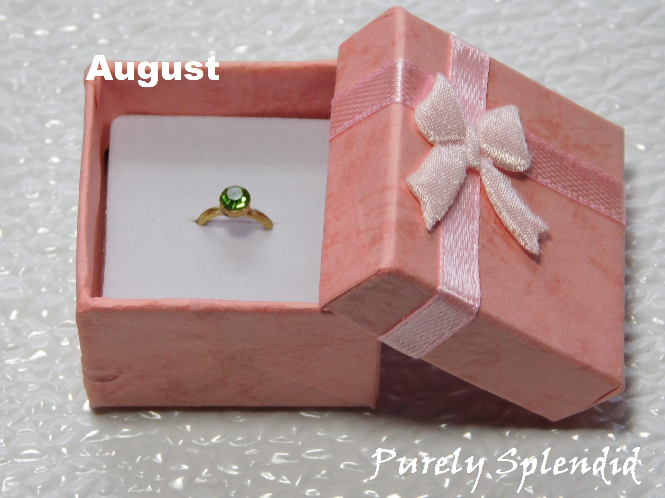 August Birthstone Ring for 18 inch dolls - peridot colored crystal on a gold band