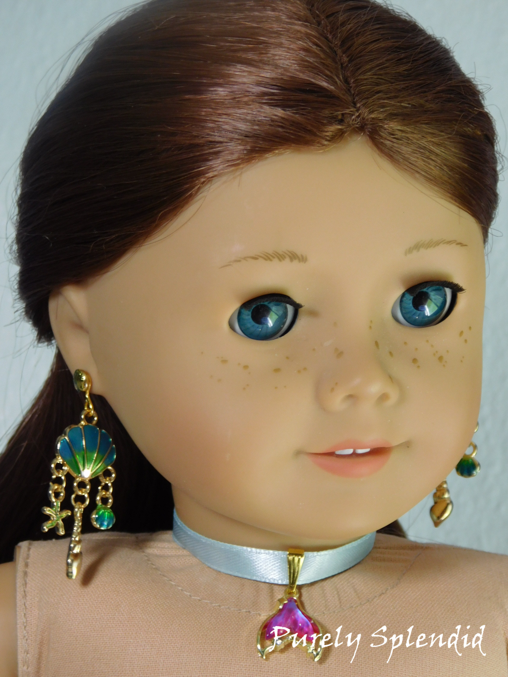 18 inch doll wearing a pair of Ariel Earrings with shells and dangling star fish