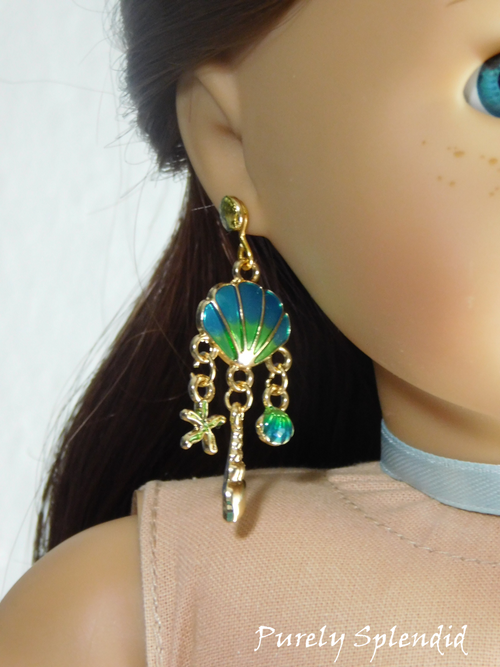 18 inch doll wearing a pair of blue Ariel Earrings with shells and dangling star fish