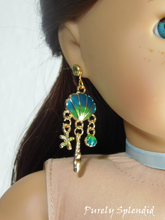 Load image into Gallery viewer, 18 inch doll wearing a pair of blue Ariel Earrings with shells and dangling star fish
