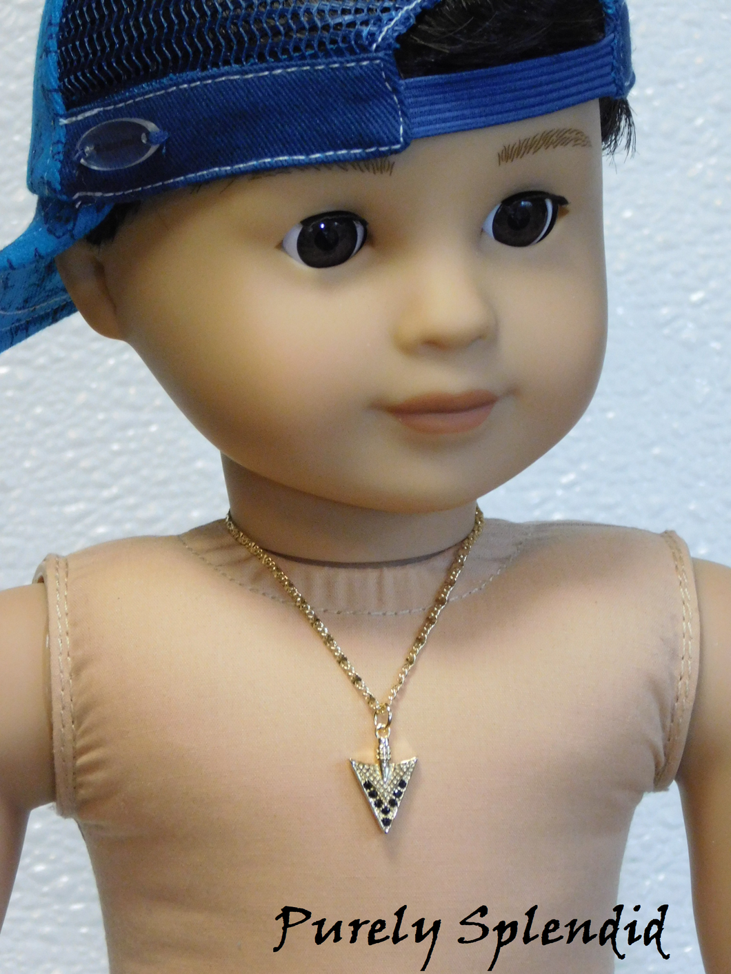 18 inch doll shown wearing a decorative gold Arrowhead Necklace with fancy gold chain