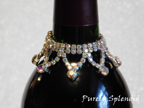 close-up of Aurora Borealis bottle bling necklace showing iridescent rhinestone strands