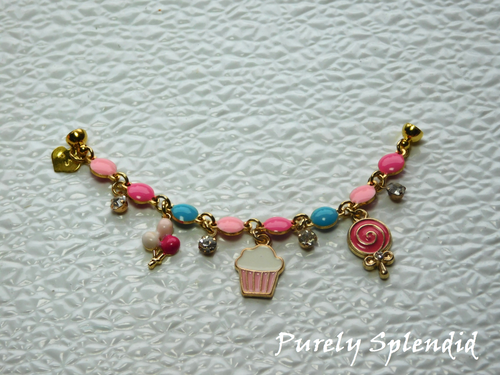 Birthday Charm Bracelet features a festive bracelet of pink and blue with cute balloons, cupcake, candy and sparkling charms. Closes with a magnetic clasp