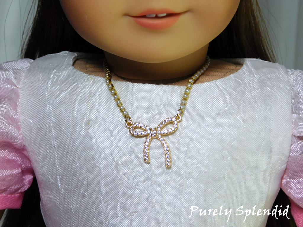 Birthday bow necklace for 18 inch girl dolls - gold plated cubic zirconia bow on pearl chain with magnetic clasp / Purely Splendid
