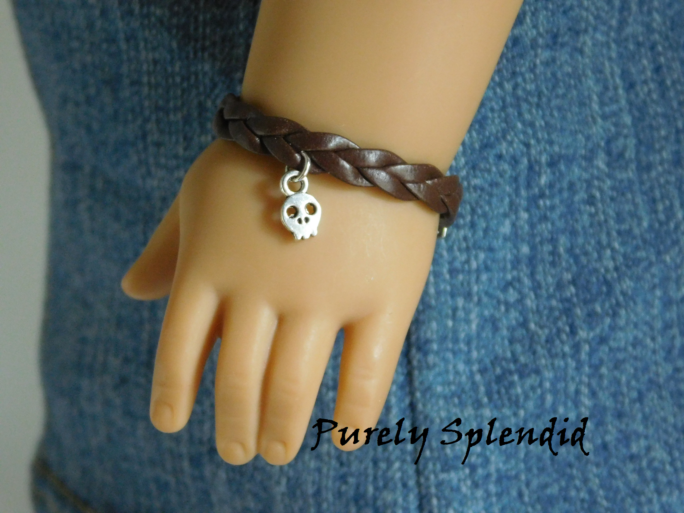 18 inch doll shown wearing a Brown Braided Bracelet with Skull Charm