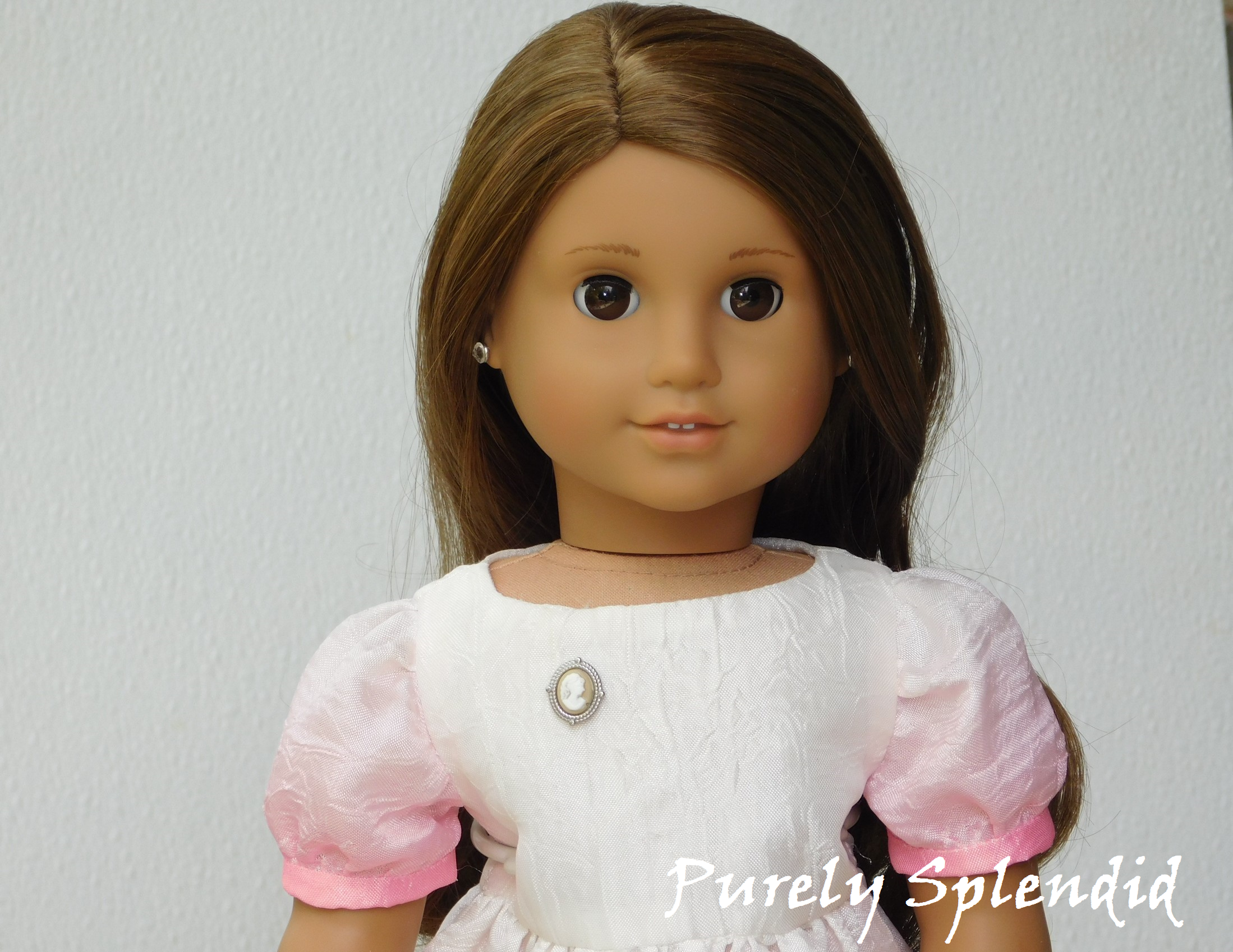 18 inch doll shown wearing the Silver and Beige Cameo Brooch