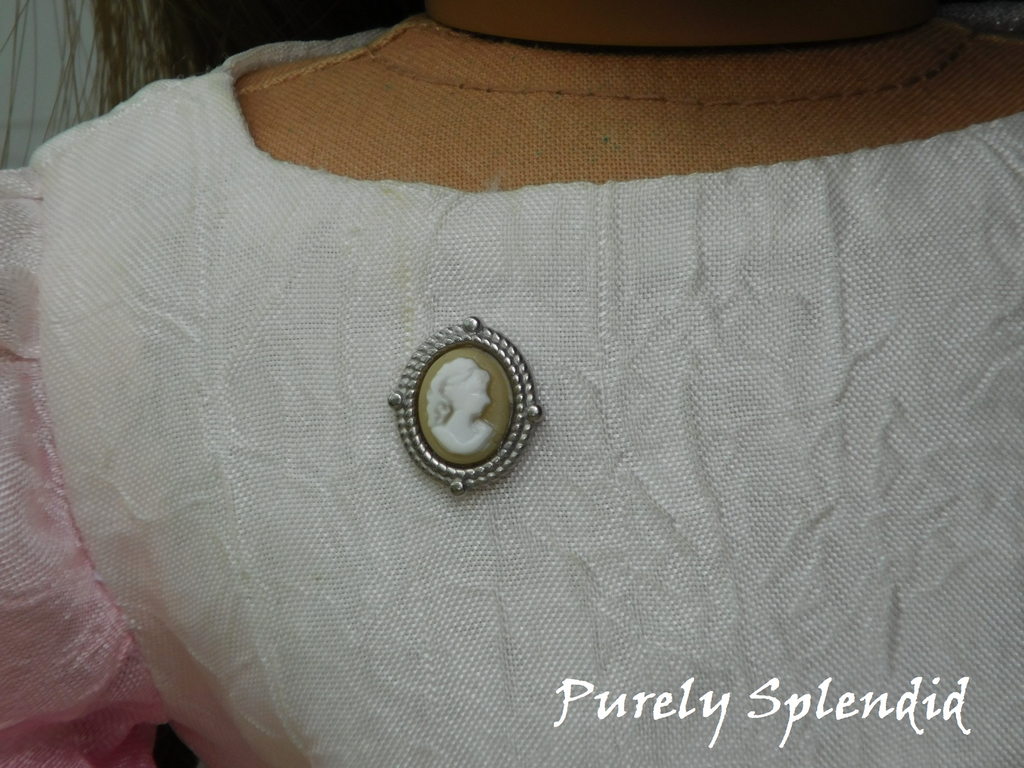 Cameo Brooch shown on the dress of an 18 inch doll