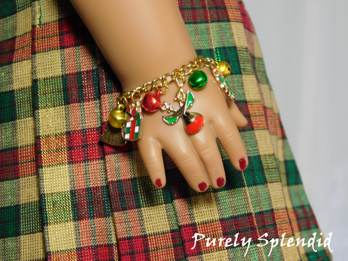 reindeer and gift charm along with festive colored bells on a gold chain for 18 inch dolls