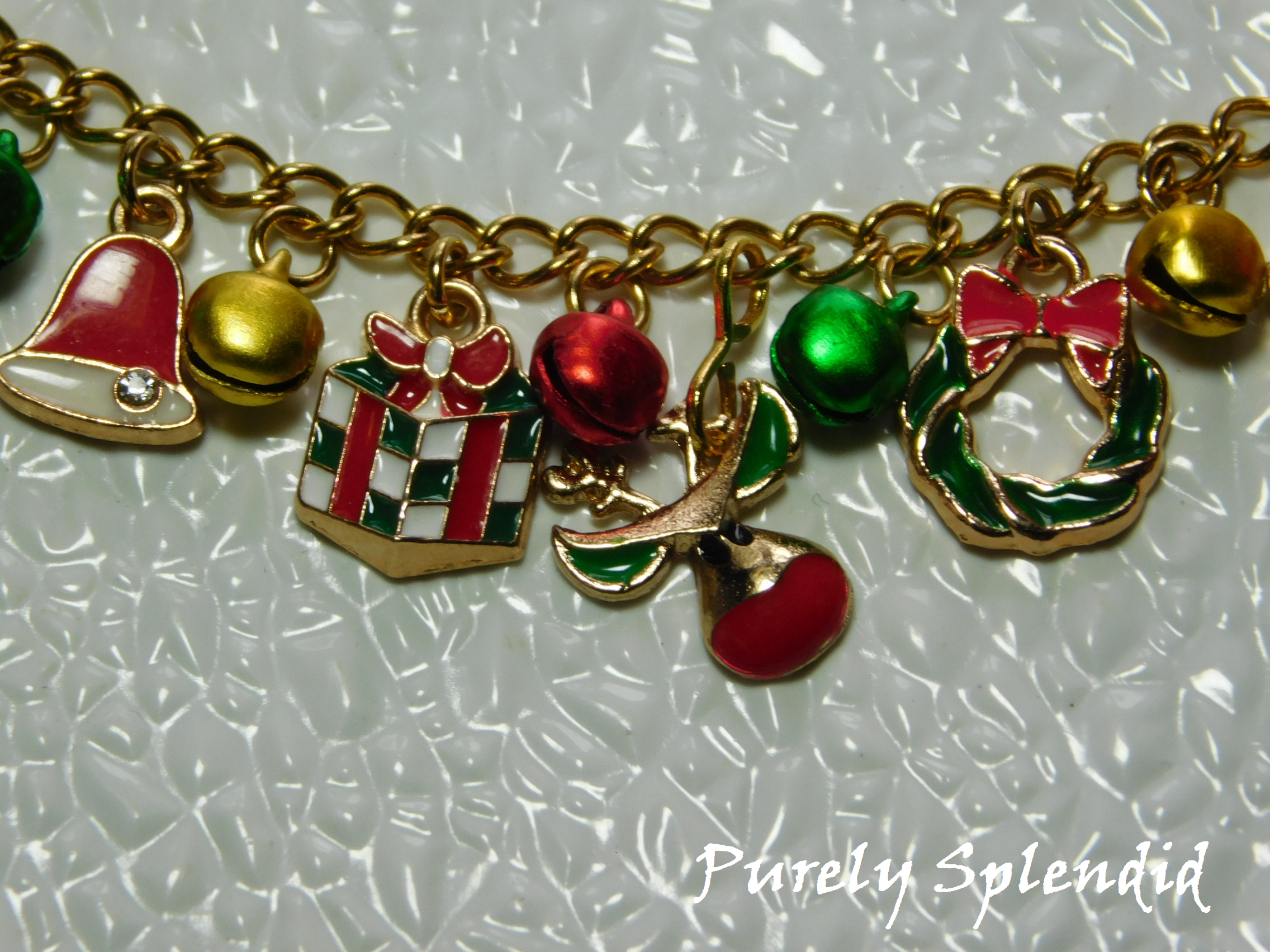 bell, gift, reindeer and wreath charms as well as festive colored bells on a gold chain - charm bracelet for 18 inch dolls