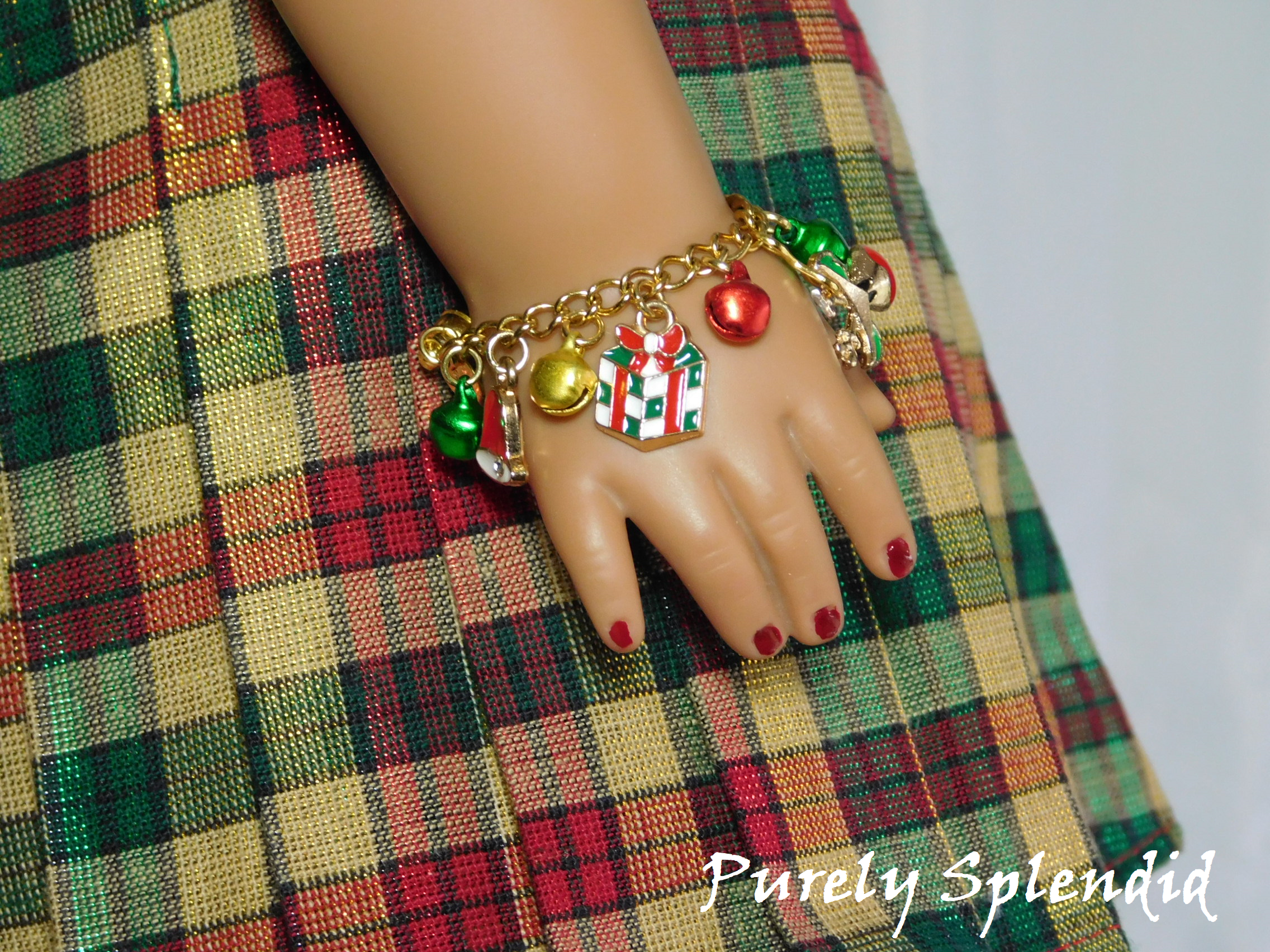 gift charm and festive colored bells on a gold chain bracelet for 18 inch dolls