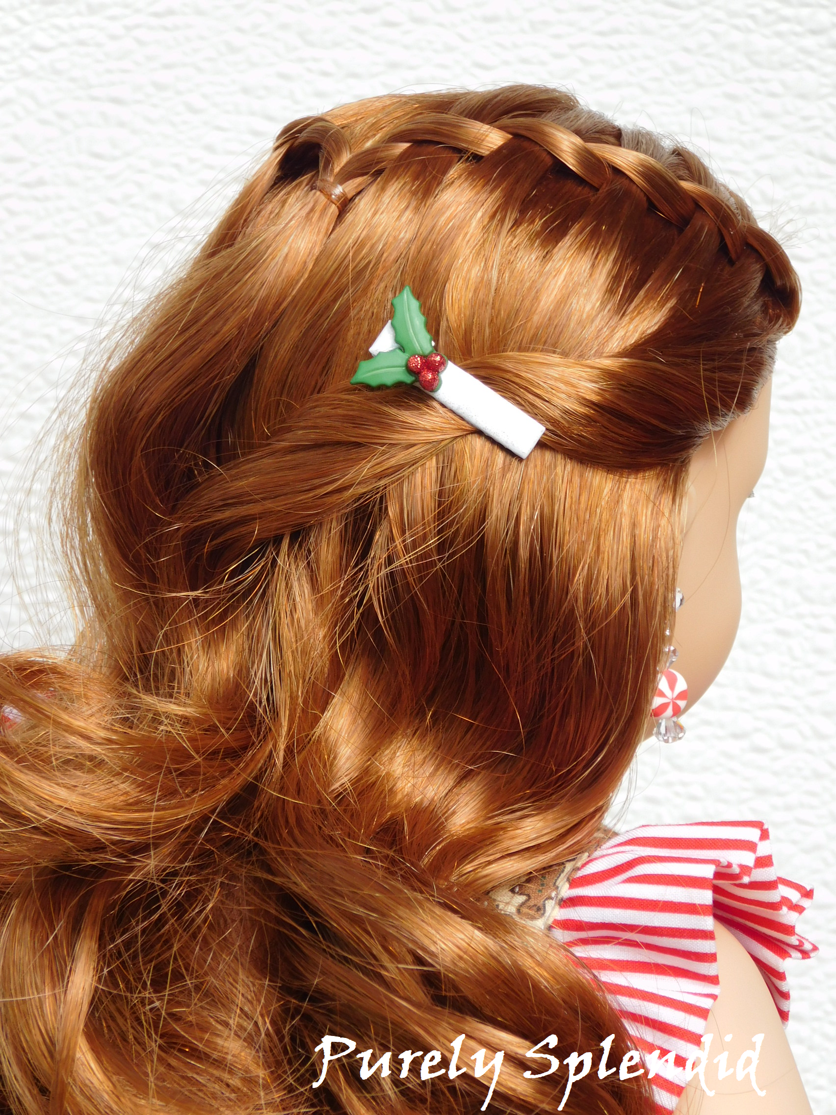 holly and berries on a white hair clip worn by an 18 inch doll