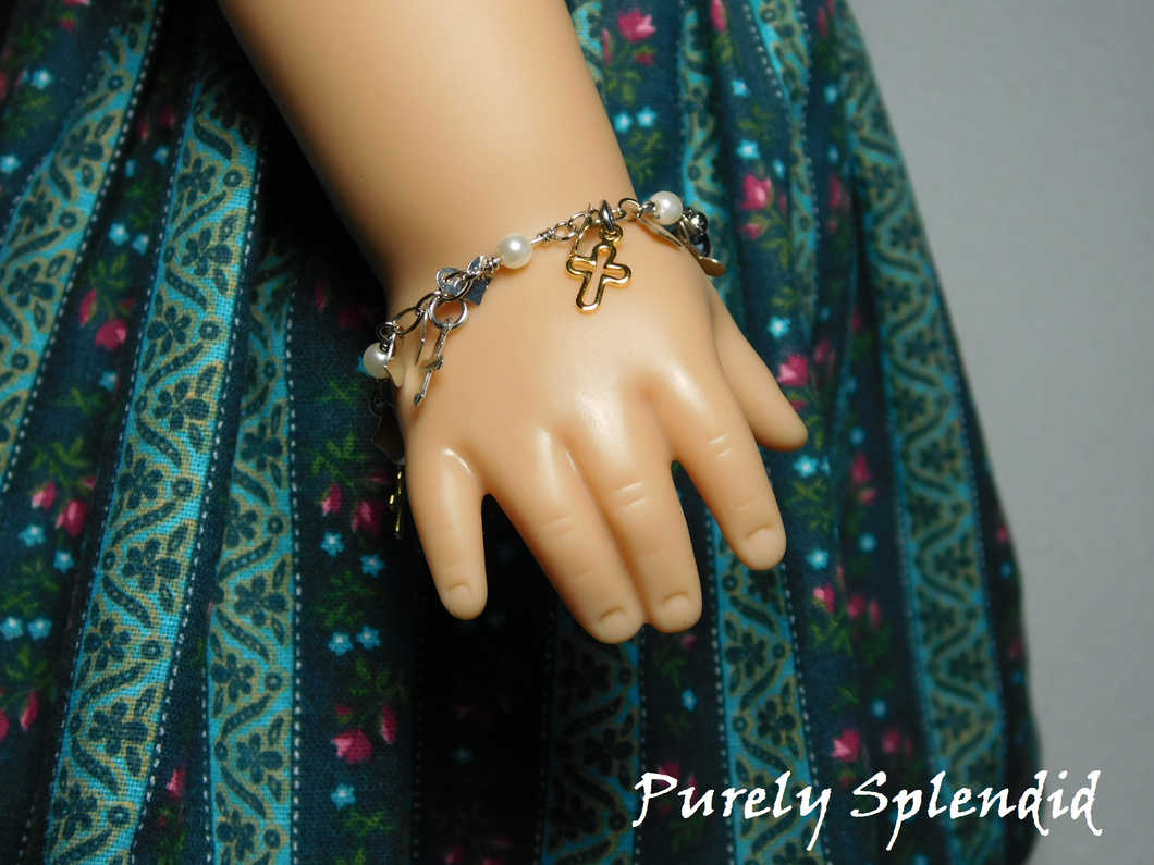 18 inch doll shown wearing Cross Charm Bracelet with silver and gold colored crosses