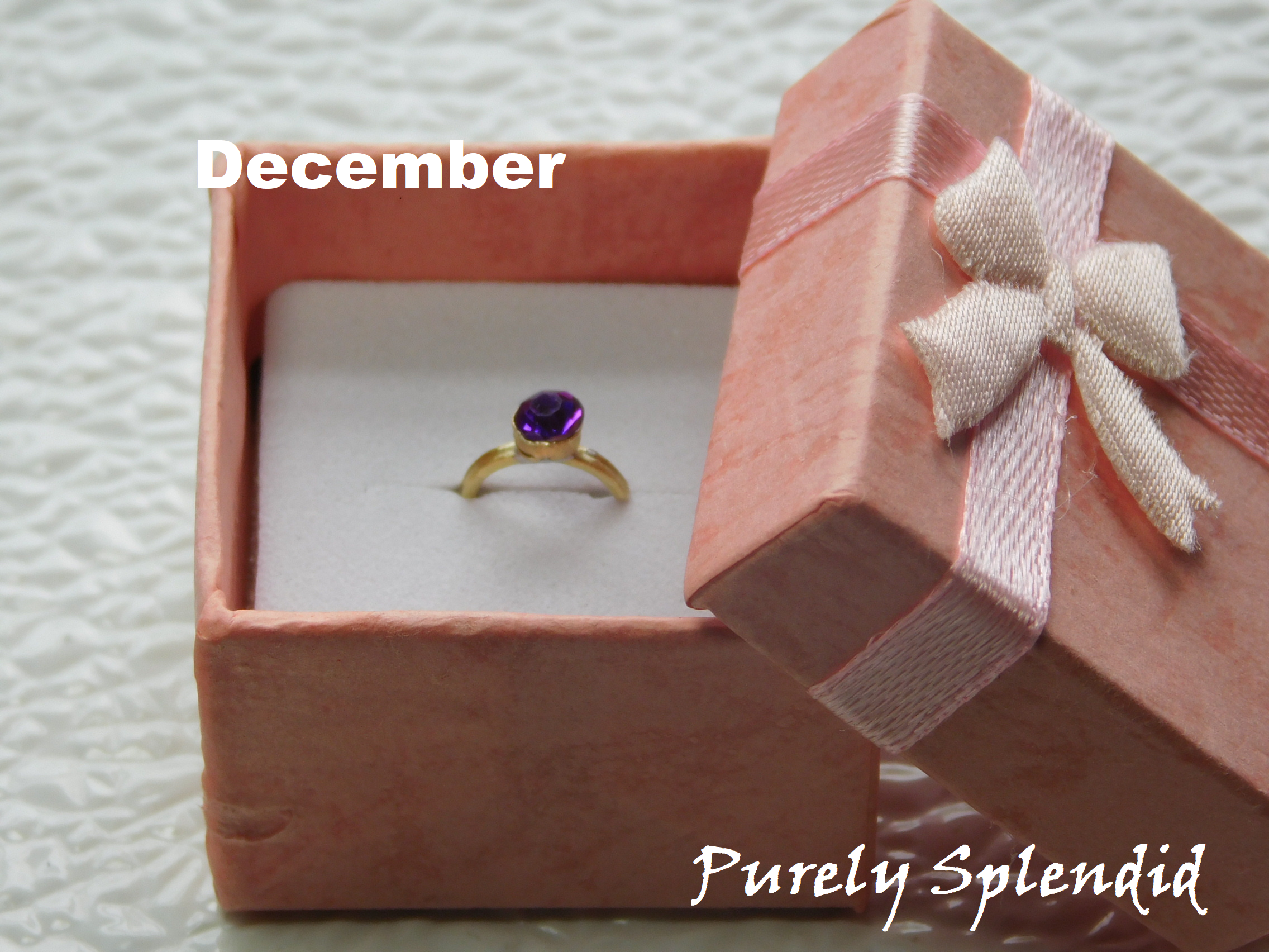 sparkling purple crystal on a gold band