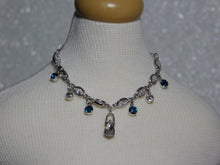 Load image into Gallery viewer, crystal necklace with four azure blue dangles and two crystal dangles and a large teardrop crystal center dangle
