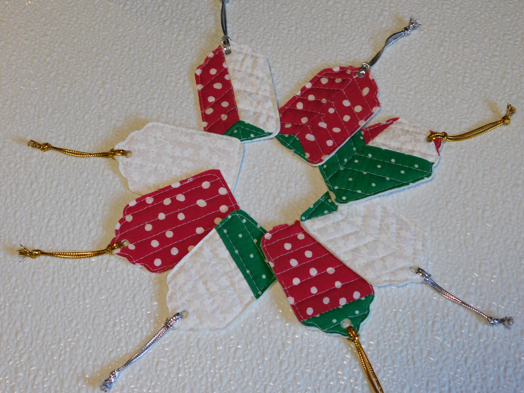 8 quilted gift tags with either a silver or gold loop. Fabric is red with random white dots green with white dots and white on white floral.