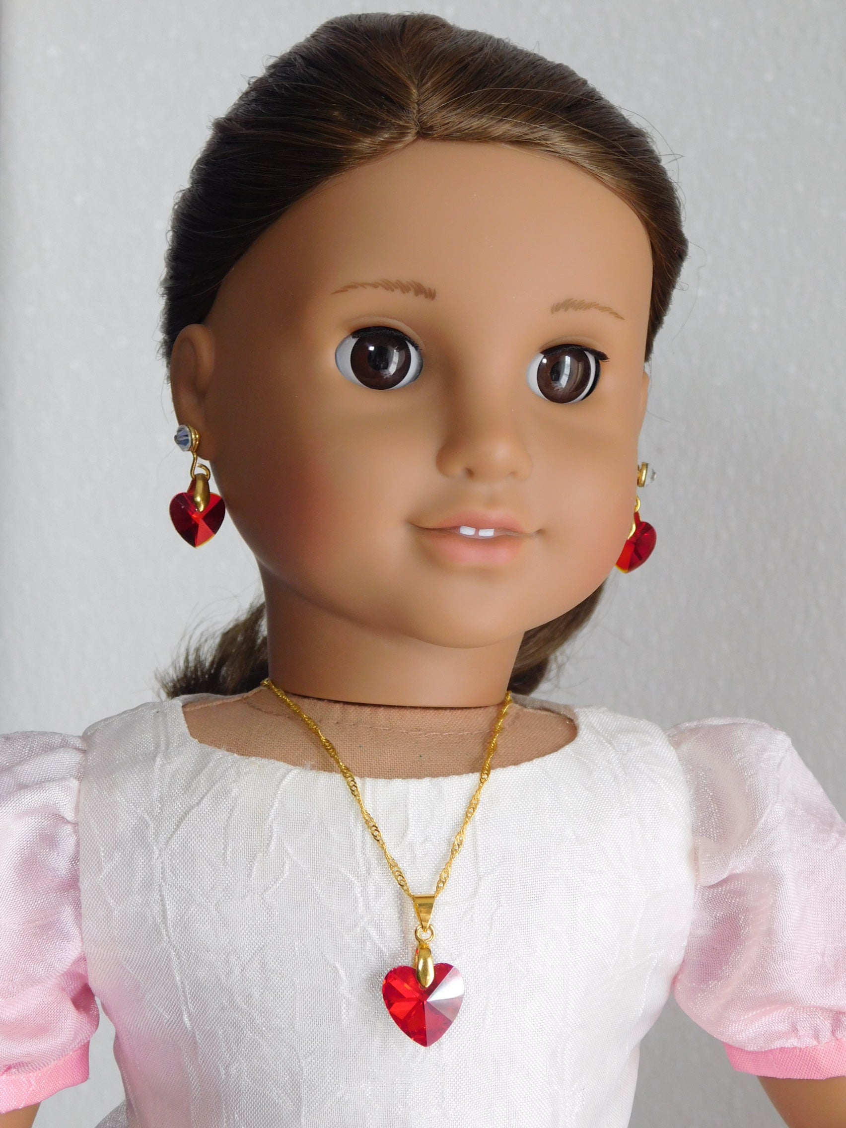 an 18 inch doll wearing a Red Crystal Heart Pendant Necklace and Earrings