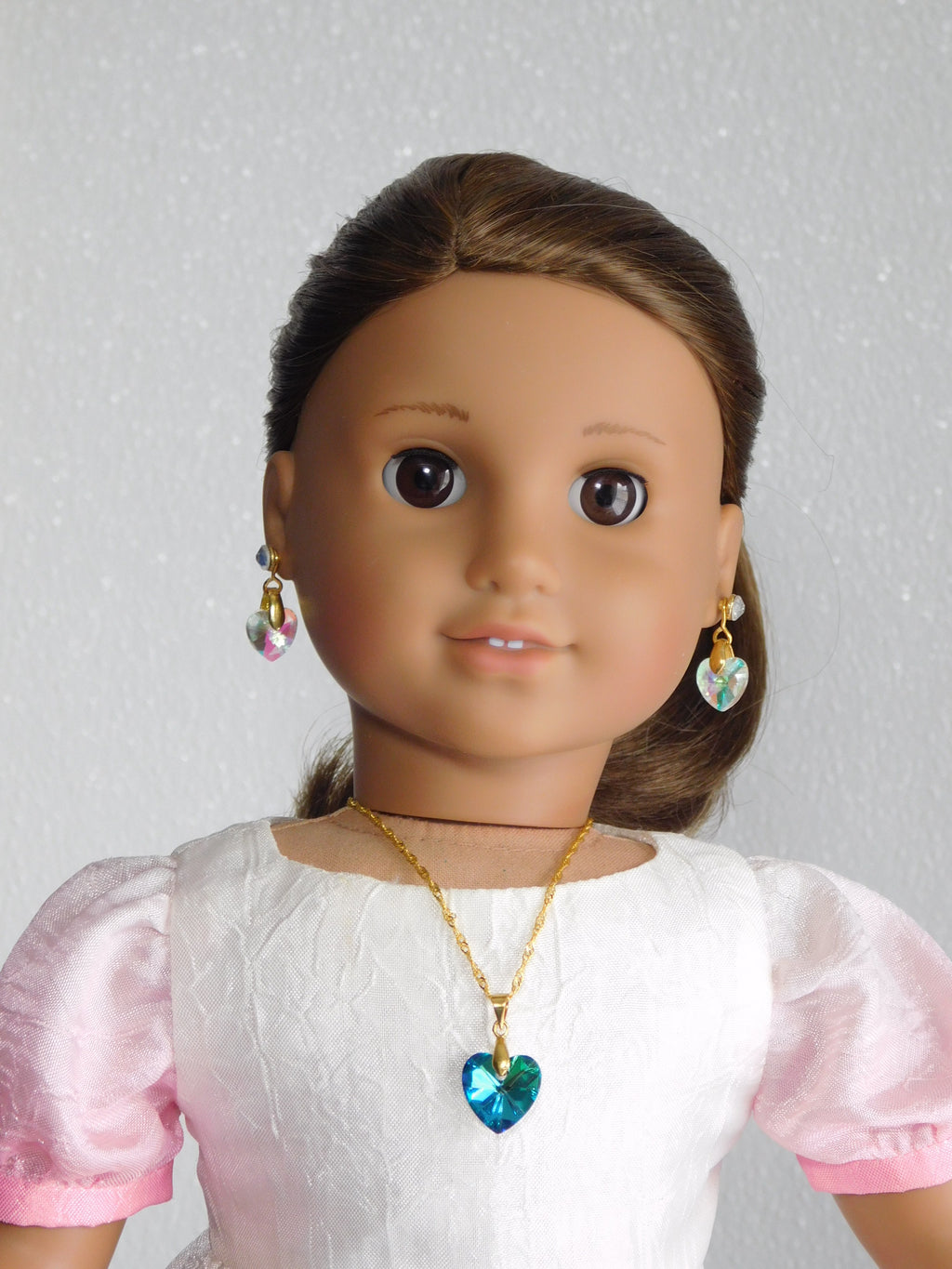 18 inch doll wearing a Teal Crystal Heart Necklace and Earrings