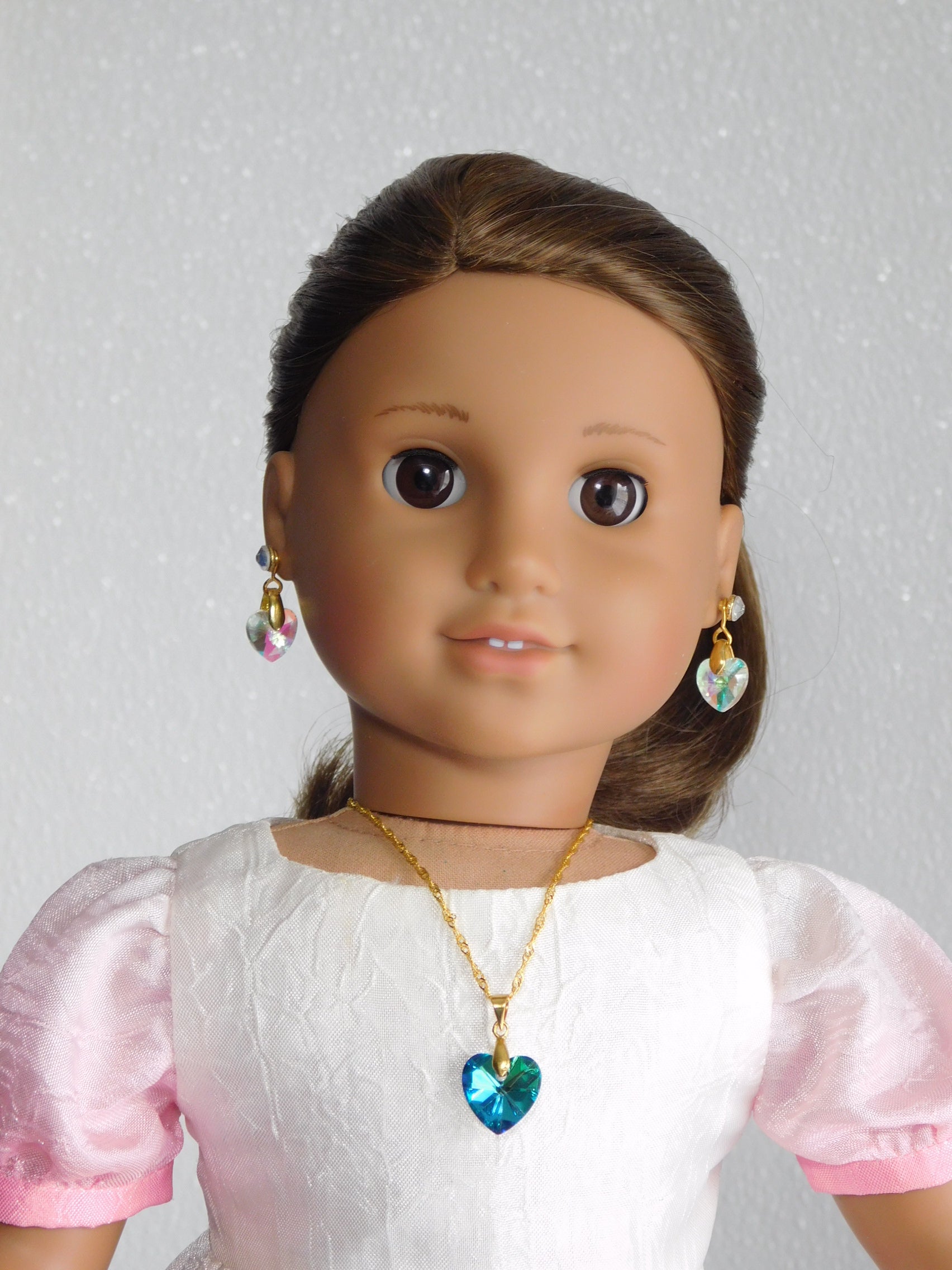 18 inch doll wearing a Teal Crystal Heart Necklace and Earrings