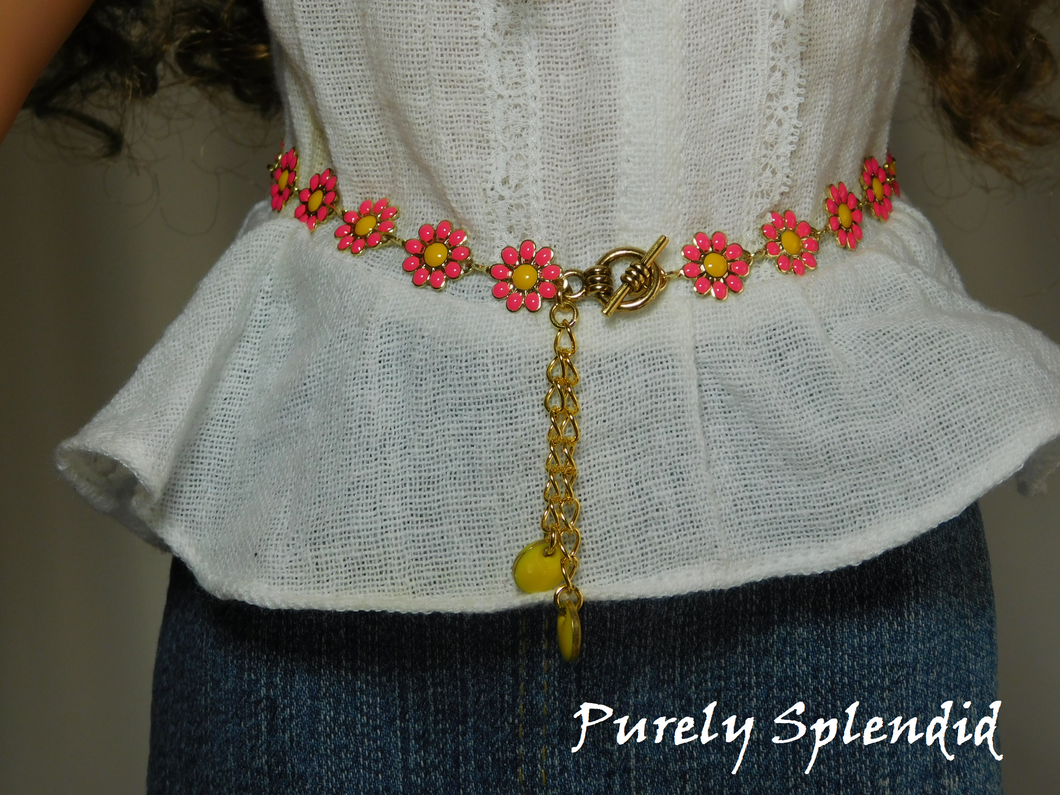 18 inch doll shown wearing a Daisy Belt with dark pink flowers, yellow centers and yellow dangles. Fastens with a toggle clasp