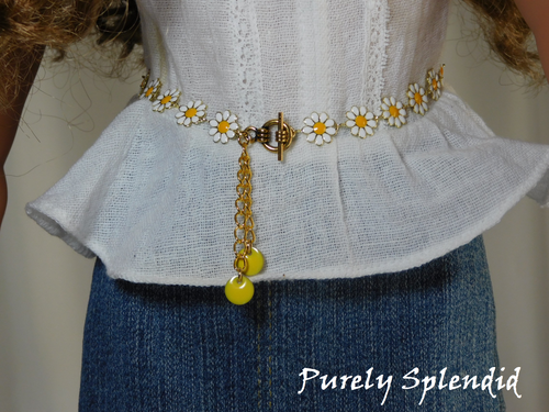 18 inch doll shown wearing a Daisy Belt with white flowers, yellow centers and yellow dangles. Fastens with a toggle clasp