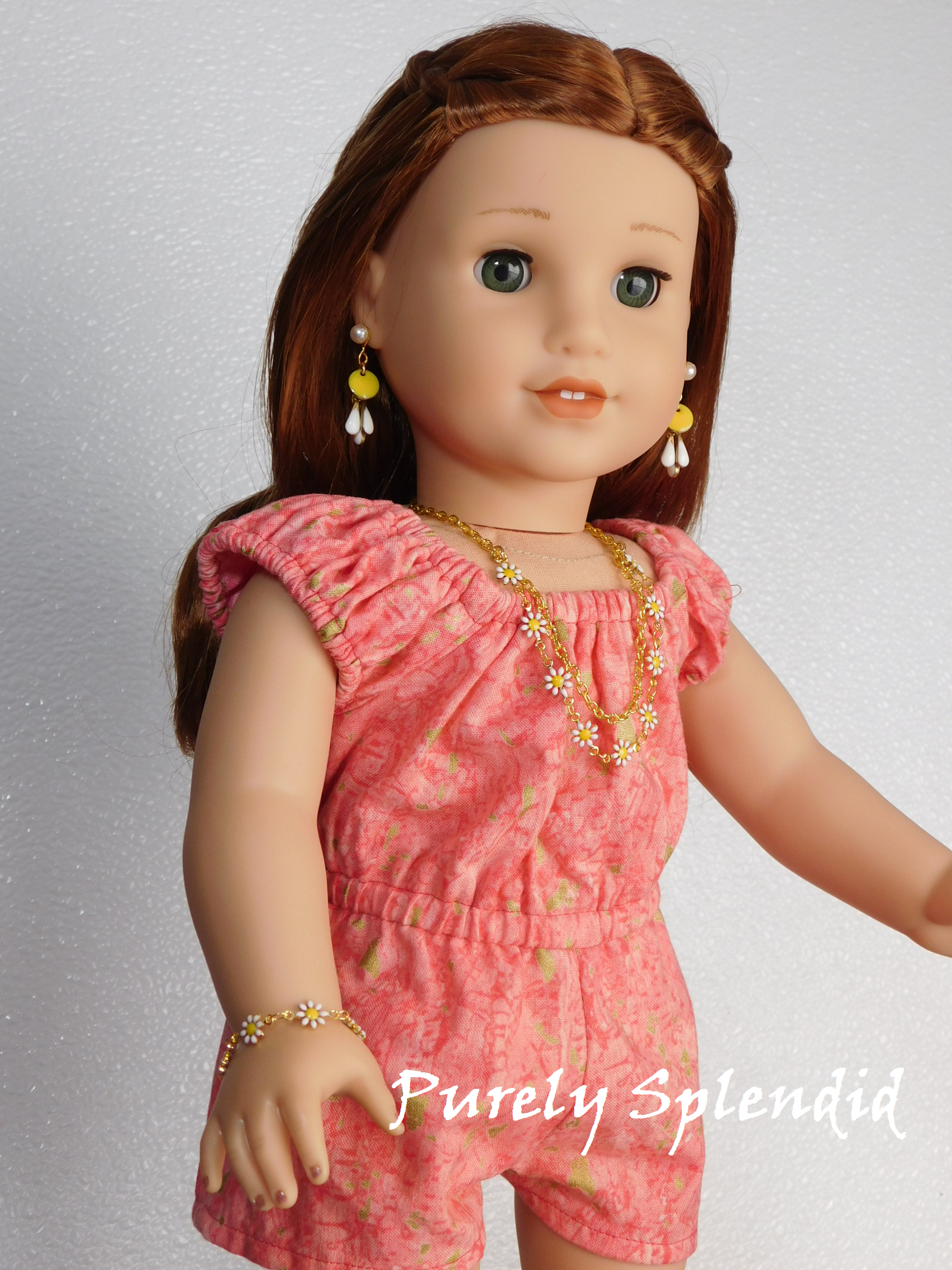 18 inch doll shown wearing a dainty Daisy Necklace and Bracelet along with Daisy Drop Earrings and Pearl 2mm Stud Earrings