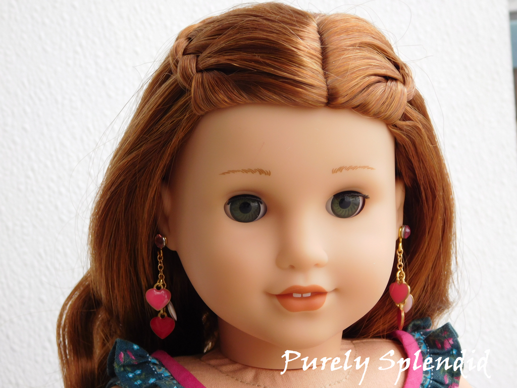 18 inch doll wearing red, pink and white dangling heart earrings