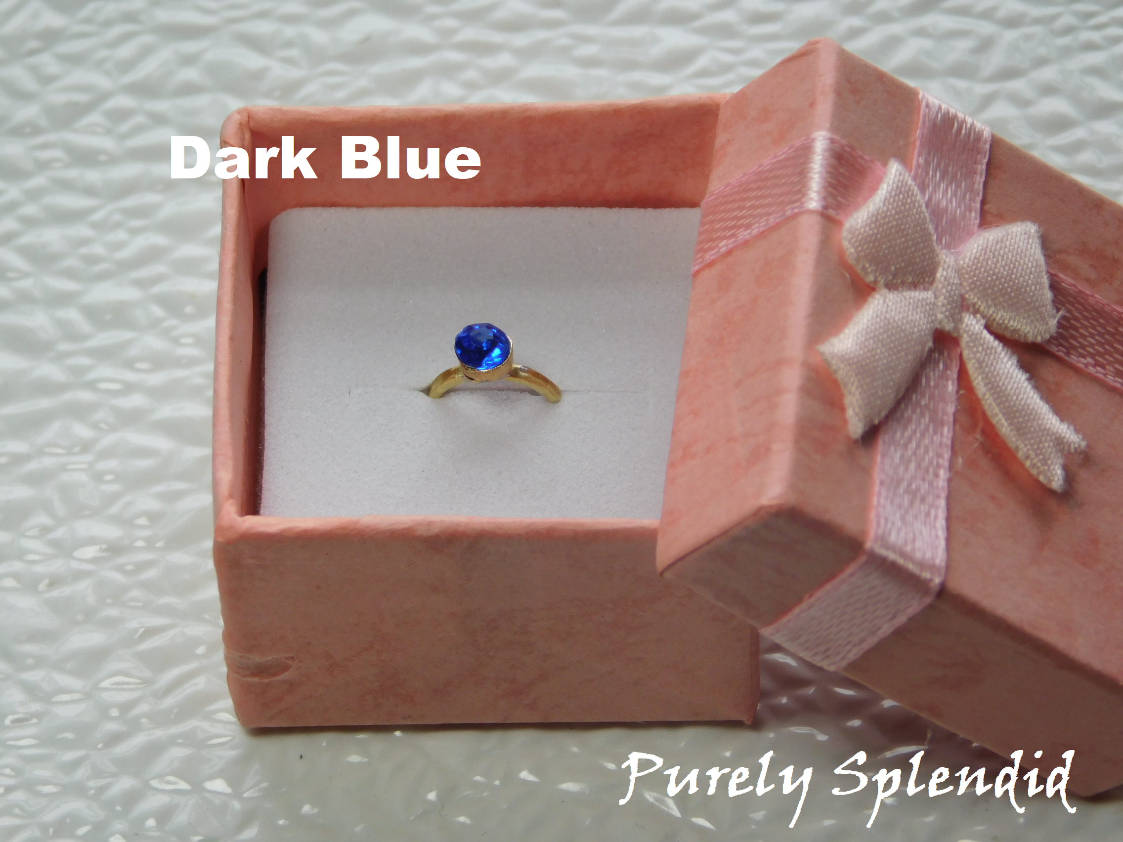 Dark Blue colored crystal on a gold band