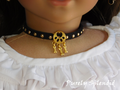 black choker with gold dots and a gold dog bone charm worn by an 18 inch doll