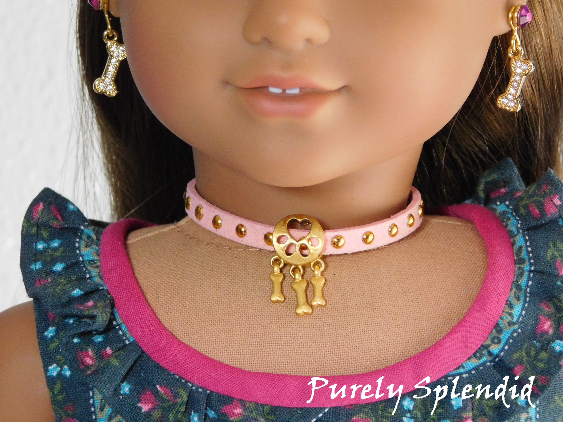 Dog Bone Choker Necklace in Pink with Gold studs worn by an 18 inch doll