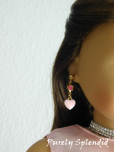 Load image into Gallery viewer, 18 inch doll wearing a pair of White Double Heart Earrings - one tiny dark pink heart with a larger white heart hanging below it
