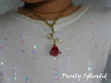 Load image into Gallery viewer, gold tipped rose hanging upside down on a gold chain worn by an 18 inch doll
