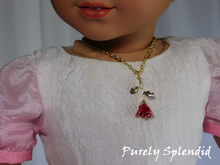 Load image into Gallery viewer, red rose tipped in gold on a gold chain worn by an 18 inch doll
