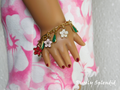 18 inch doll wearing a Flower Lei Bracelet with red, pink and white Hibiscus flowers and green dangles