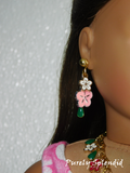 18 inch doll wearing a pair of Flower Lei Earrings with white and pink Hibiscus flowers and green dangle