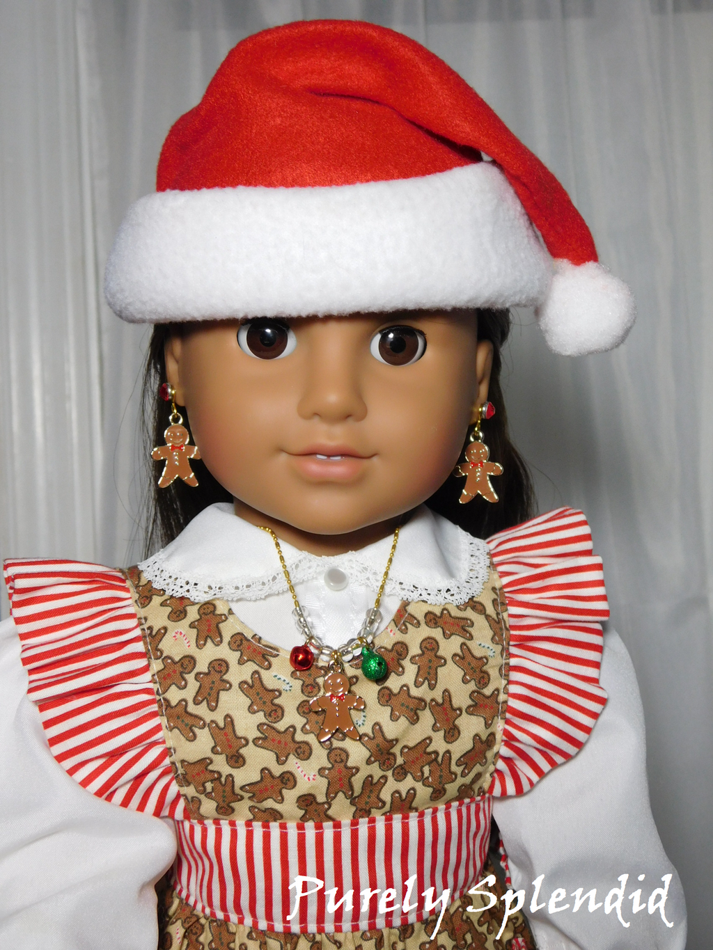 18 inch doll wearing a gingerbread man necklace with red and green jingle bells